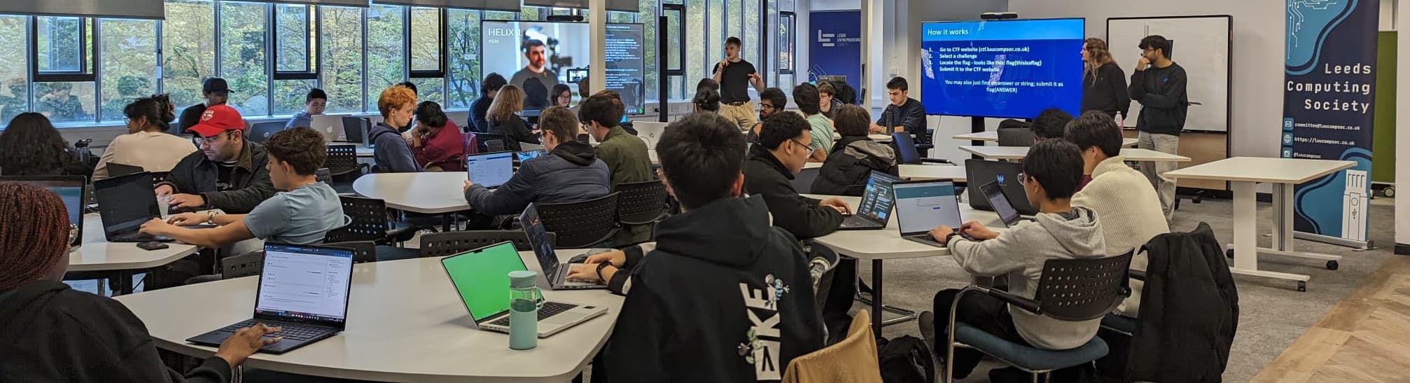 Banner showing participants coding at a previous Computing Society event